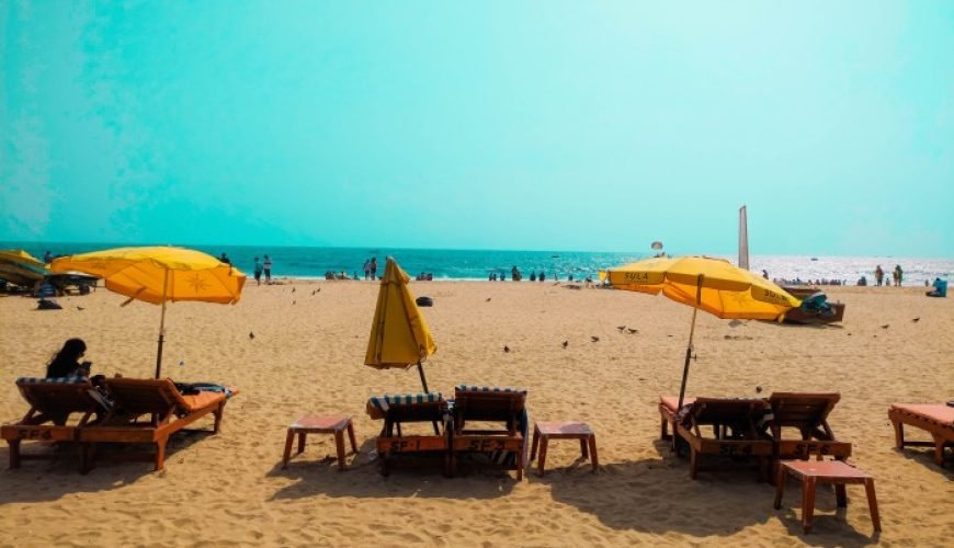 a group of chairs and umbrellas on a beach