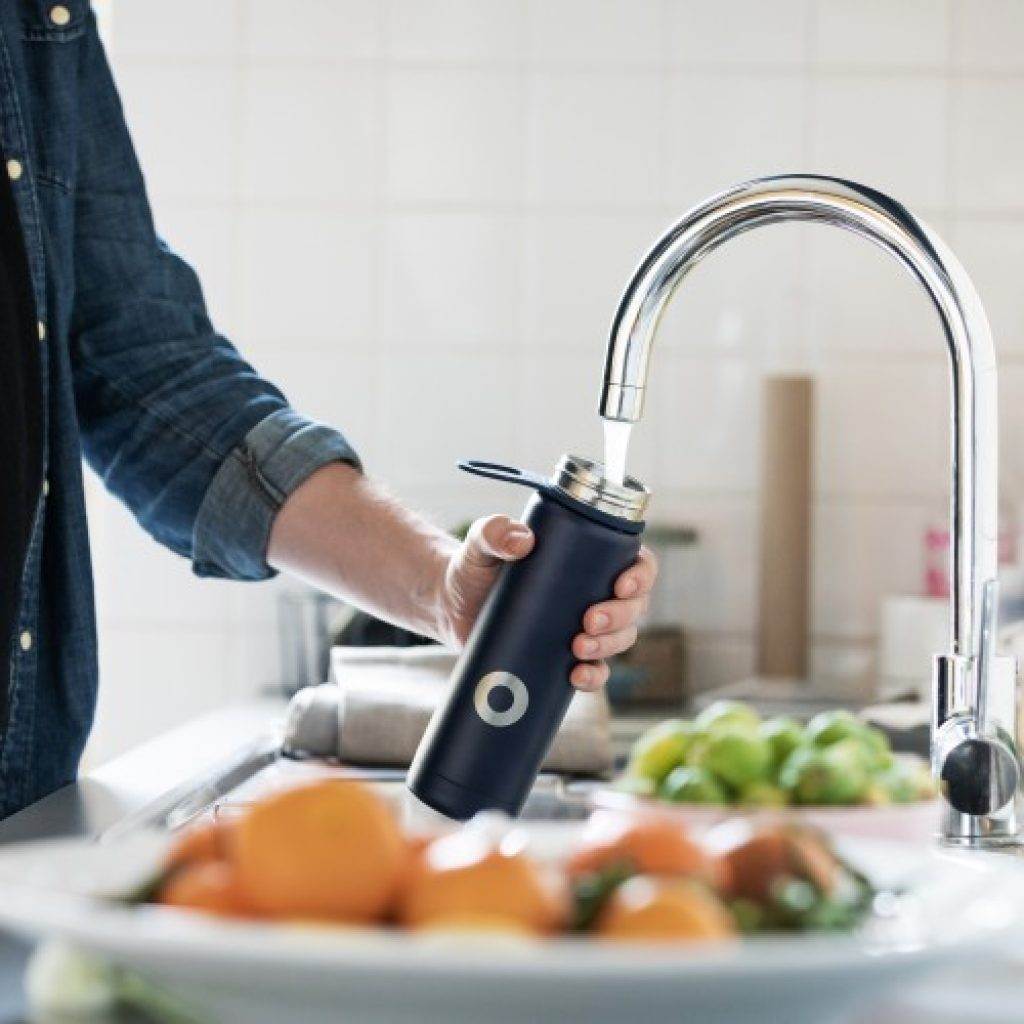 a man filled his flask with tap water