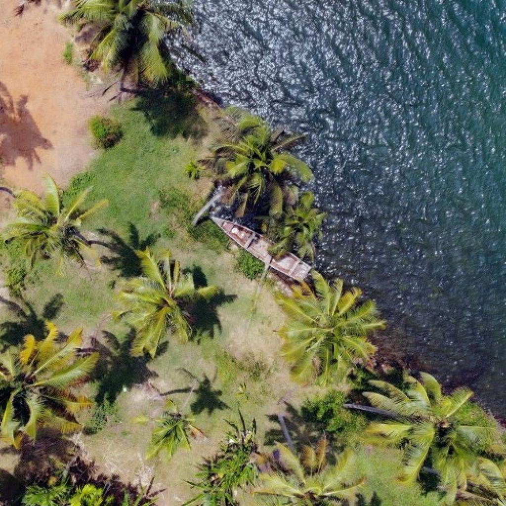 a boat on the shore of a body of water