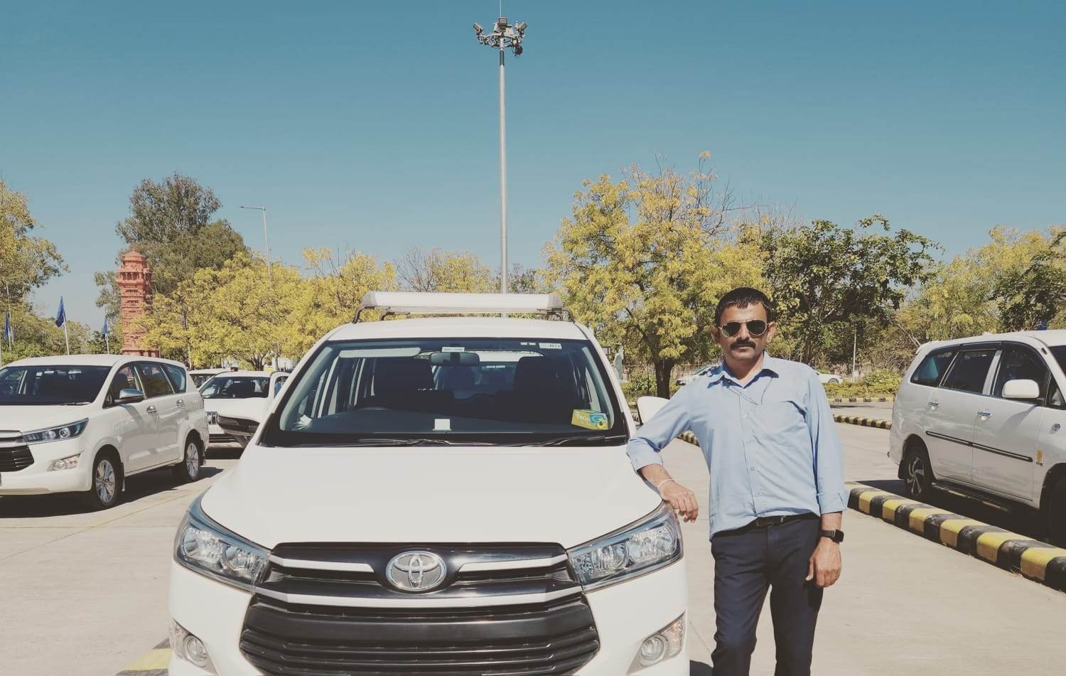 a man standing next to a white car