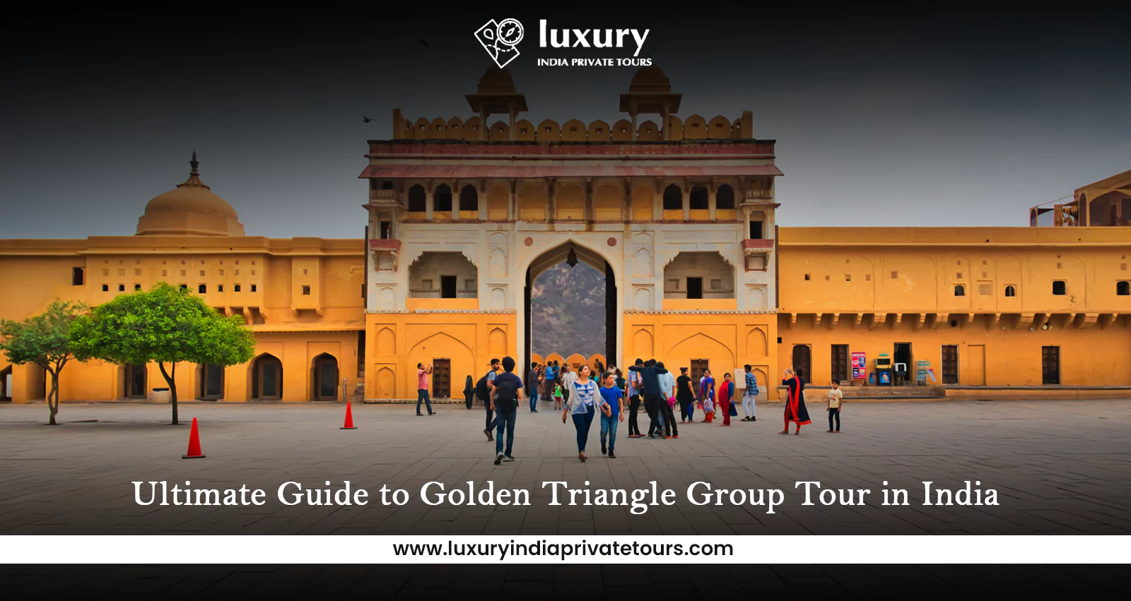 Tourists exploring historic fort gate in Jaipur during Golden Triangle tour in India