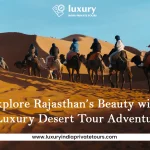 Travelers riding camels across desert dunes during a Rajasthan luxury tour adventure