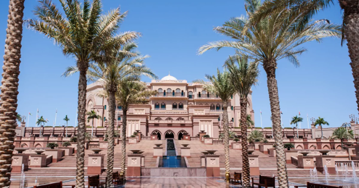 Luxurious hotel with palm trees and fountain, ideal for Rajasthan royal tours