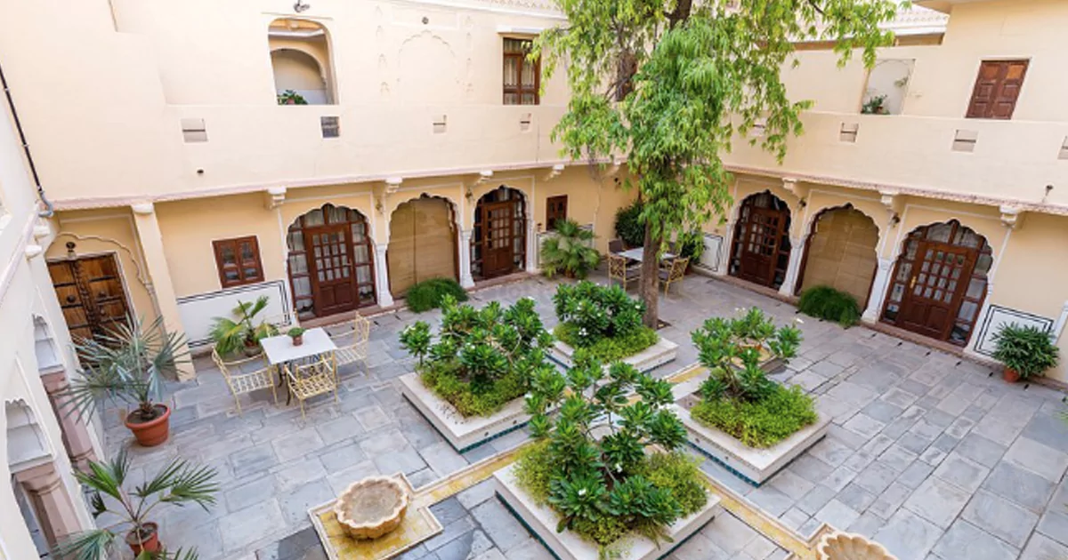Courtyard of Samode Haveli in Jaipur with gardens, fountains, and seating