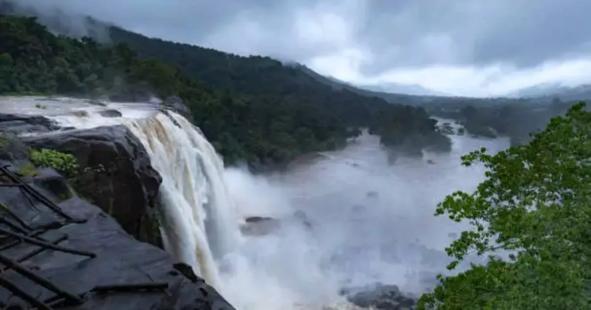 Athirappilly Waterfalls with misty plunge in lush green valley 