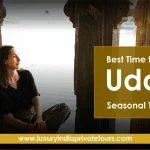 Tourist enjoying serene view of Udaipur Lake seasonal travel tips