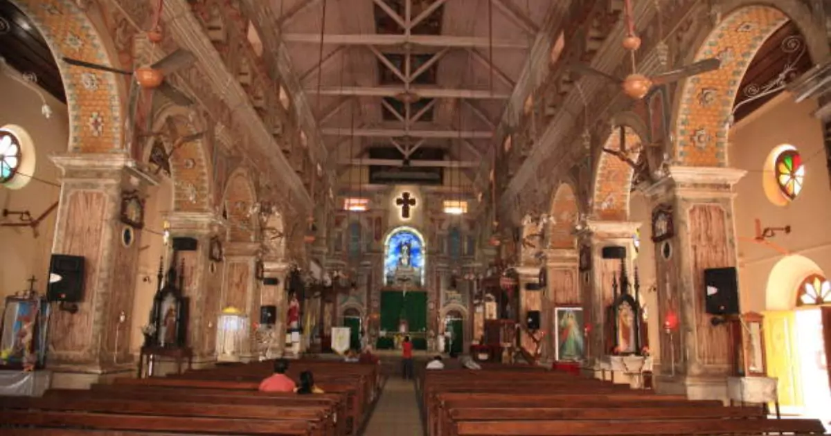 Interior view of a historic church in Fort Cochin with ornate colonial design.