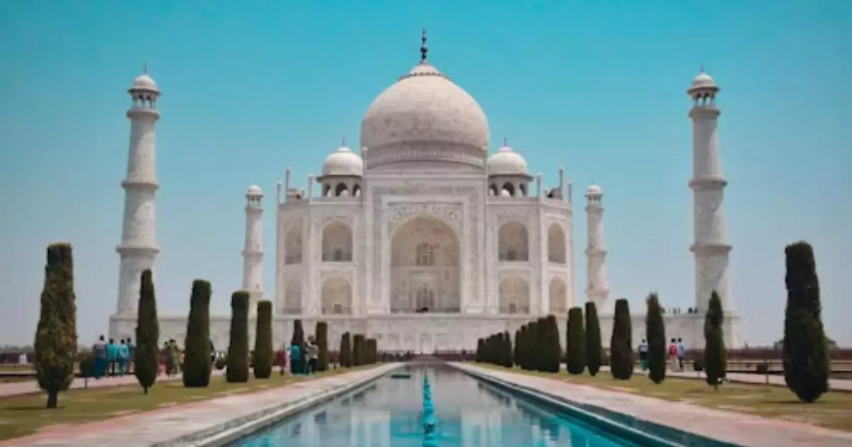 Taj Mahal in Agra with blue sky and water reflection, a highlight of Delhi Agra Jaipur tour 