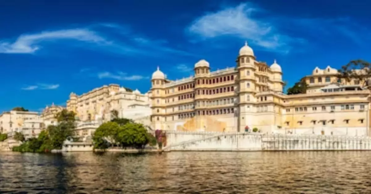 Udaipur palace by lake under clear summer sky with luxury tour vibe
